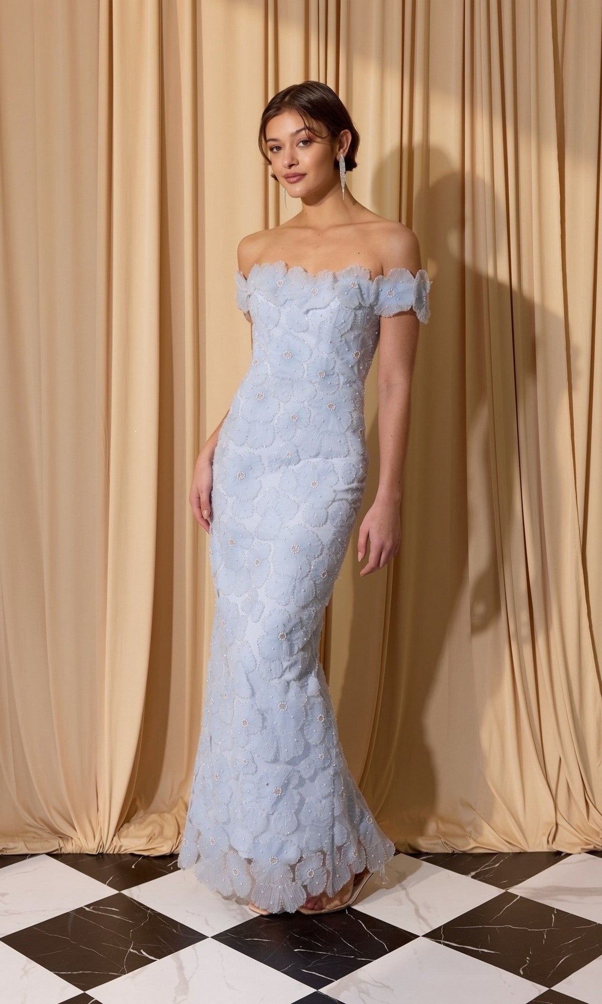 A woman wearing the Long Prom Dress: Eureka EK205 in powder blue stands on a black-and-white tiled floor before beige curtains.